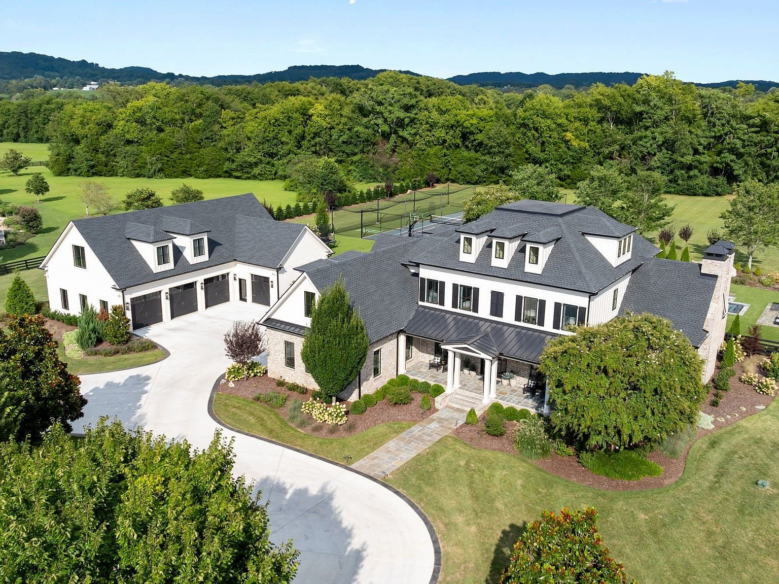 aerial view of the estate, fields, and wooded surroundings