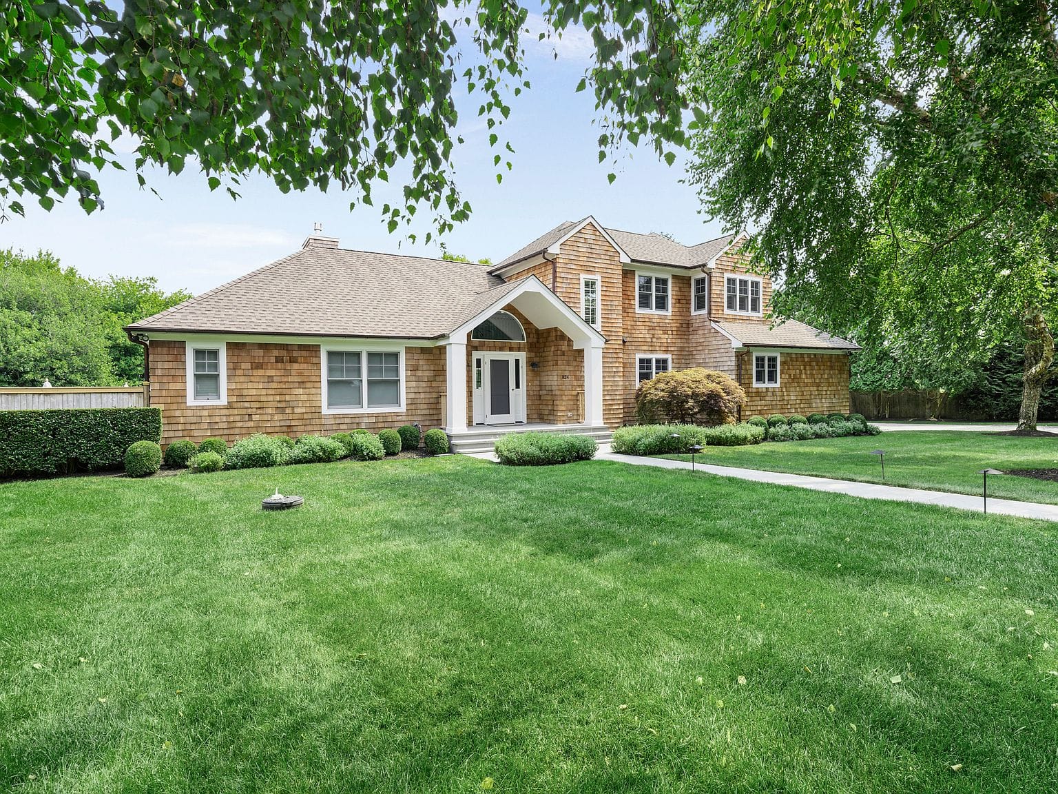 cedar shingle residence amid manicured grounds